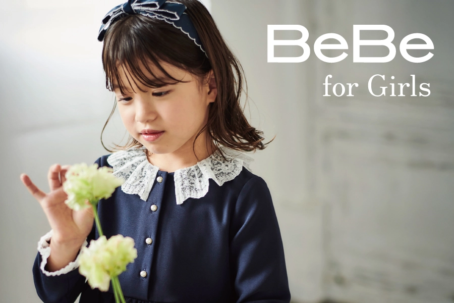 BeBe（べべ）女の子向けセレモニースタイル：ネイビーのボレロとジャンパースカートのコーディネート